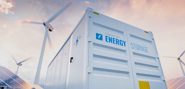 Image of a large industrial energy storage system with windmills and the sky and clouds in the background.