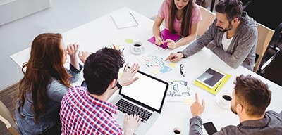 A team around a table collaborating on a project